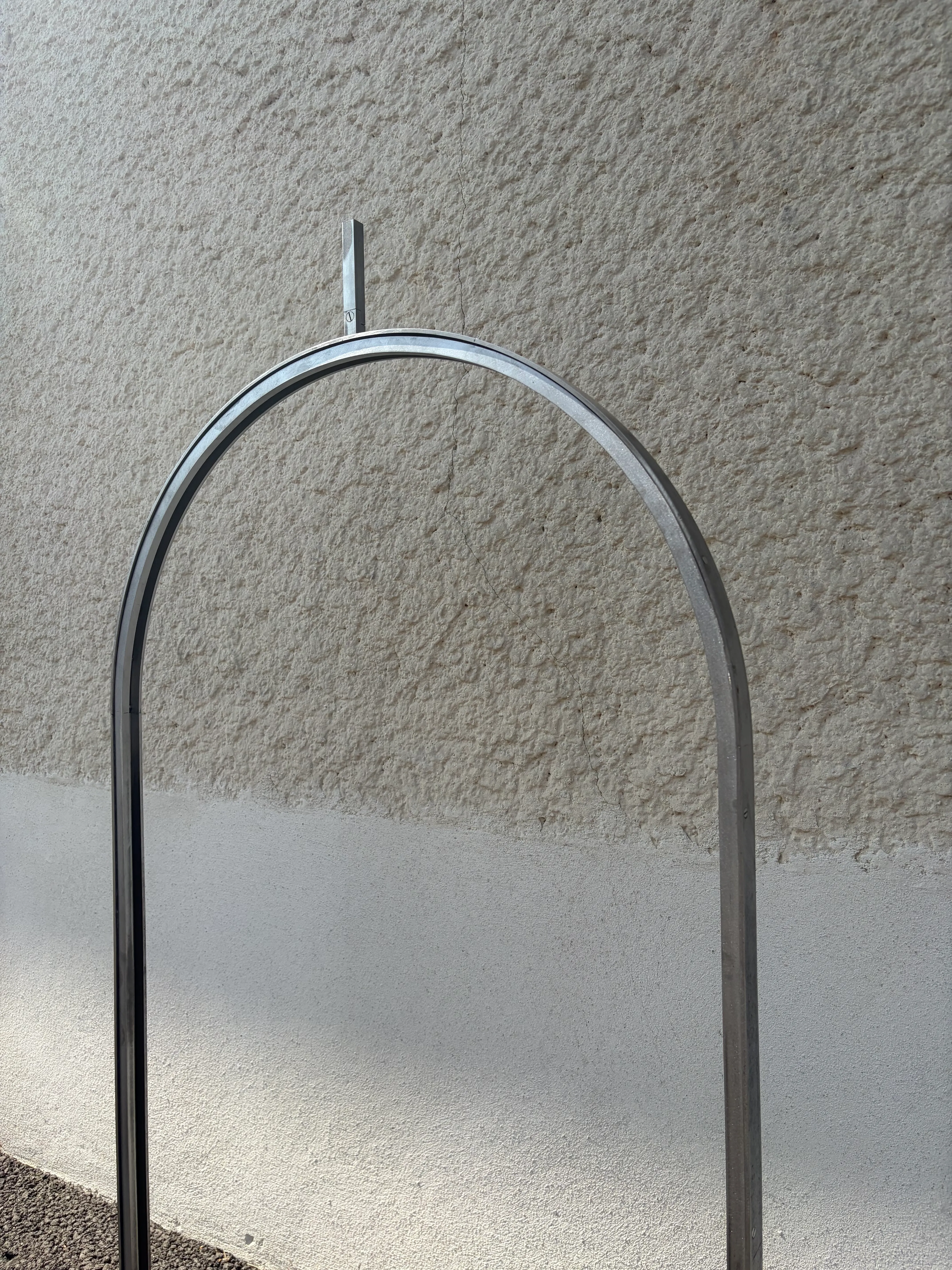Détail du cintrage et des finitions du châssis en acier sur mesure Vue détaillée de la courbe et des finitions d'un châssis en acier brut cintré pour vitrail, montrant la précision de la métallerie.